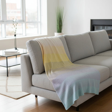 Gradient towel with yellow to blue colors on a wooden surface